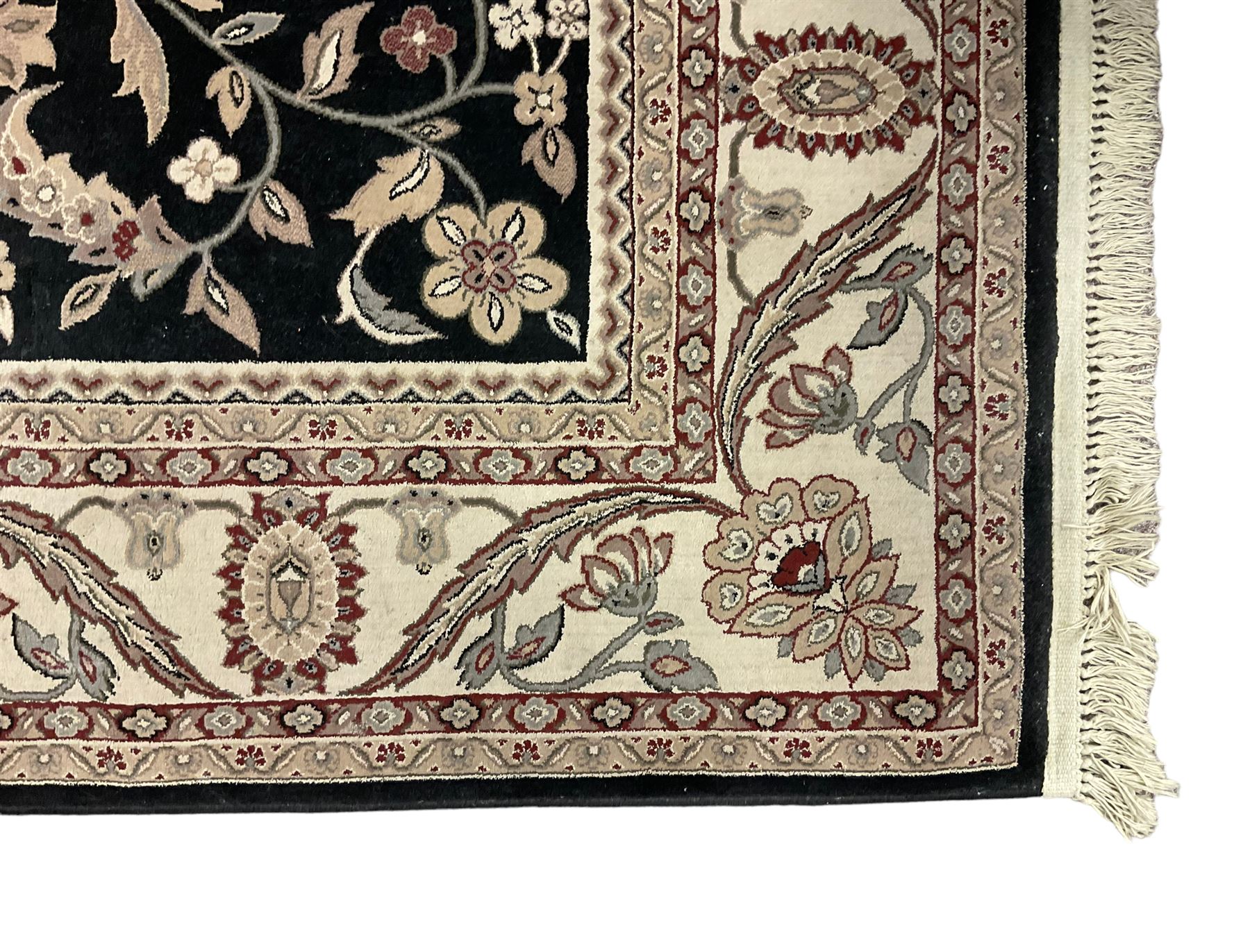 Persian design dark indigo ground rug, the field decorated with trailing branches and foliate motifs, repeating scrolling border with stylised plant motifs