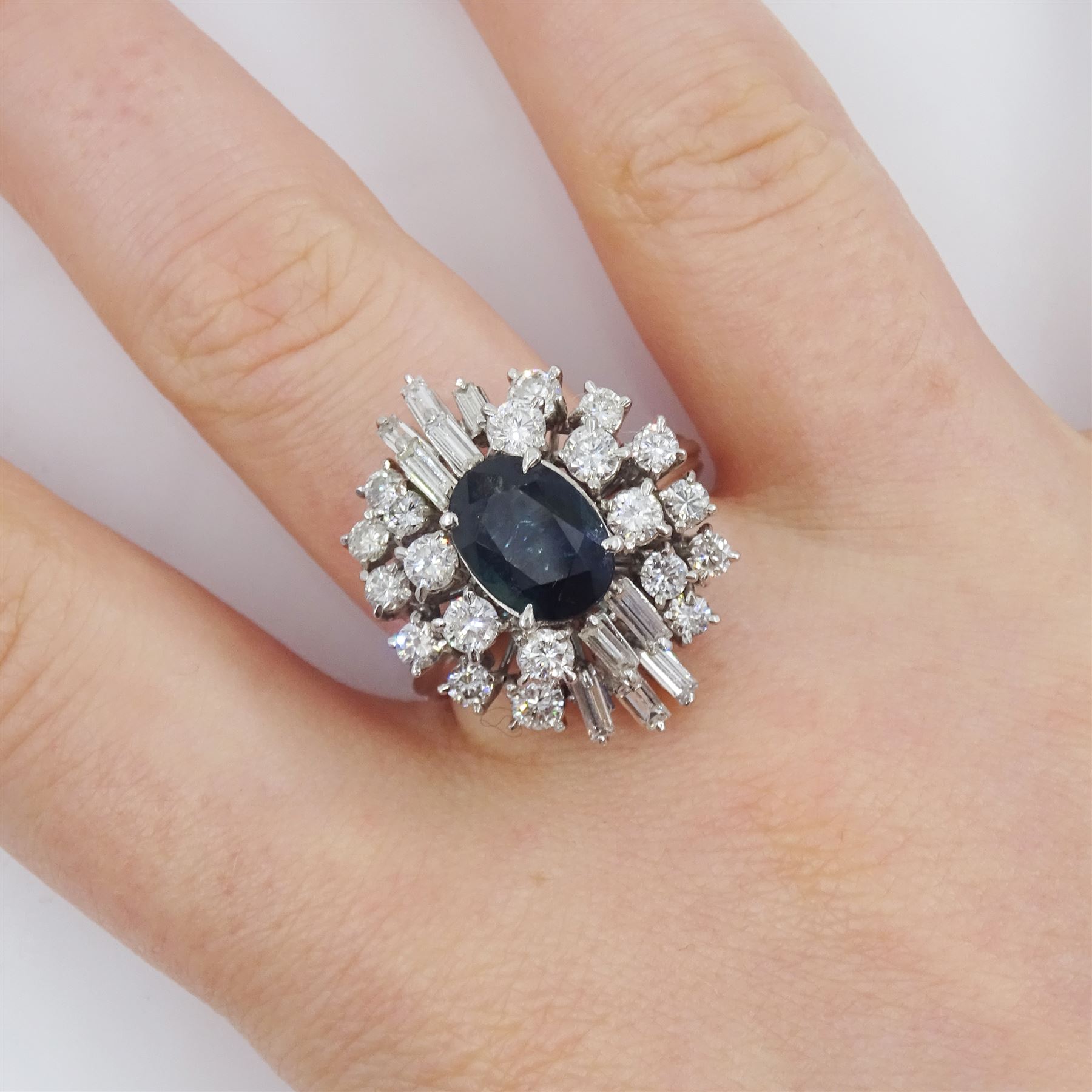 18ct white gold oval cut sapphire, baguette cut and round brilliant cut diamond cluster ring, sapphire approx 1.70 carat, total diamond weight approx 1.90 carat