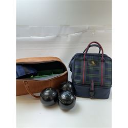 Two sets of flat green bowls, to include a ladies and gentlemans set, both contained within bowling bags