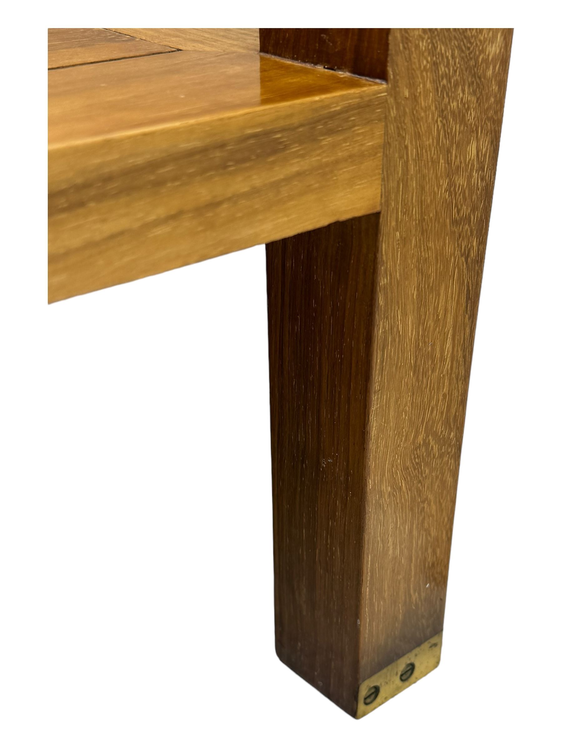 Starbay Tobago cherry wood coffee table, rectangular top with two inset glass panels, central drawer with louvred front and brass handles, flanked by open shelving, raised on square supports with metal corner brackets