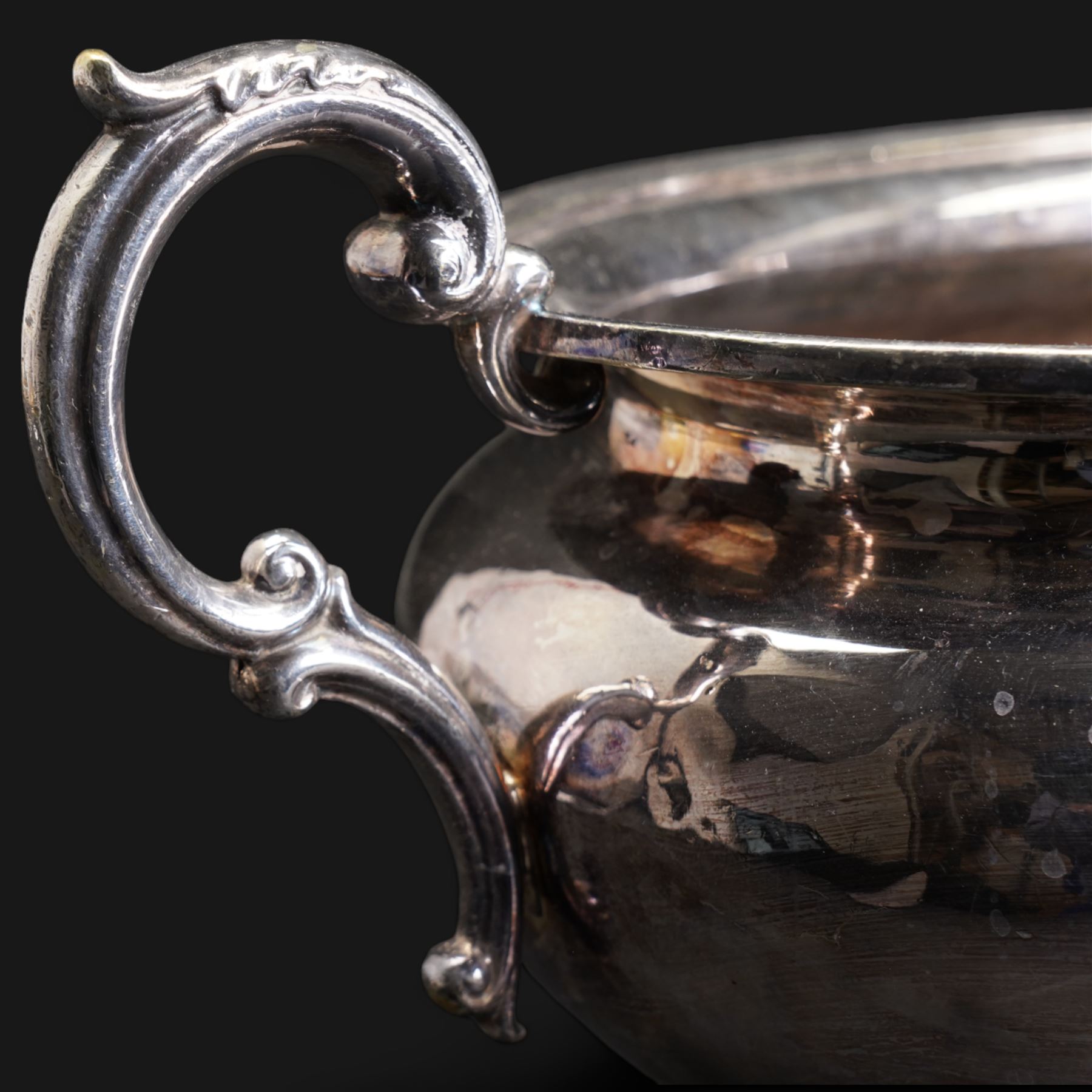 20th century silver-plated bottle coaster with grape vine decoration, cut glass claret jug with silver-plated mounts, H30cm and an early 20th century Elkington silver plate soup tureen, lacking cover 