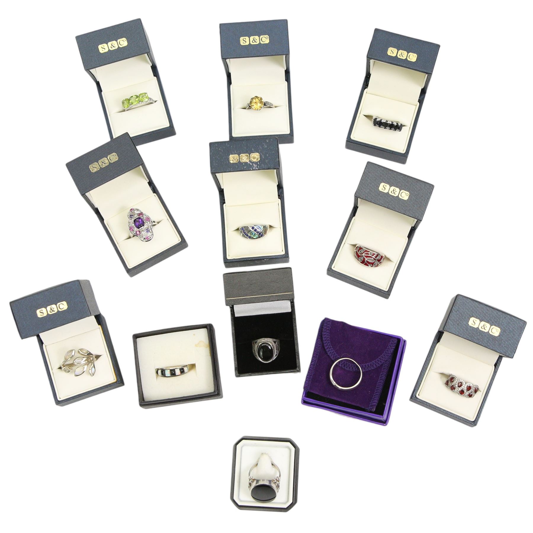 Twelve silver gemset rings, including a jet ring with Celtic design shoulders and a garnet two row cluster ring, amethyst cluster ring and an early 20th century citrine ring