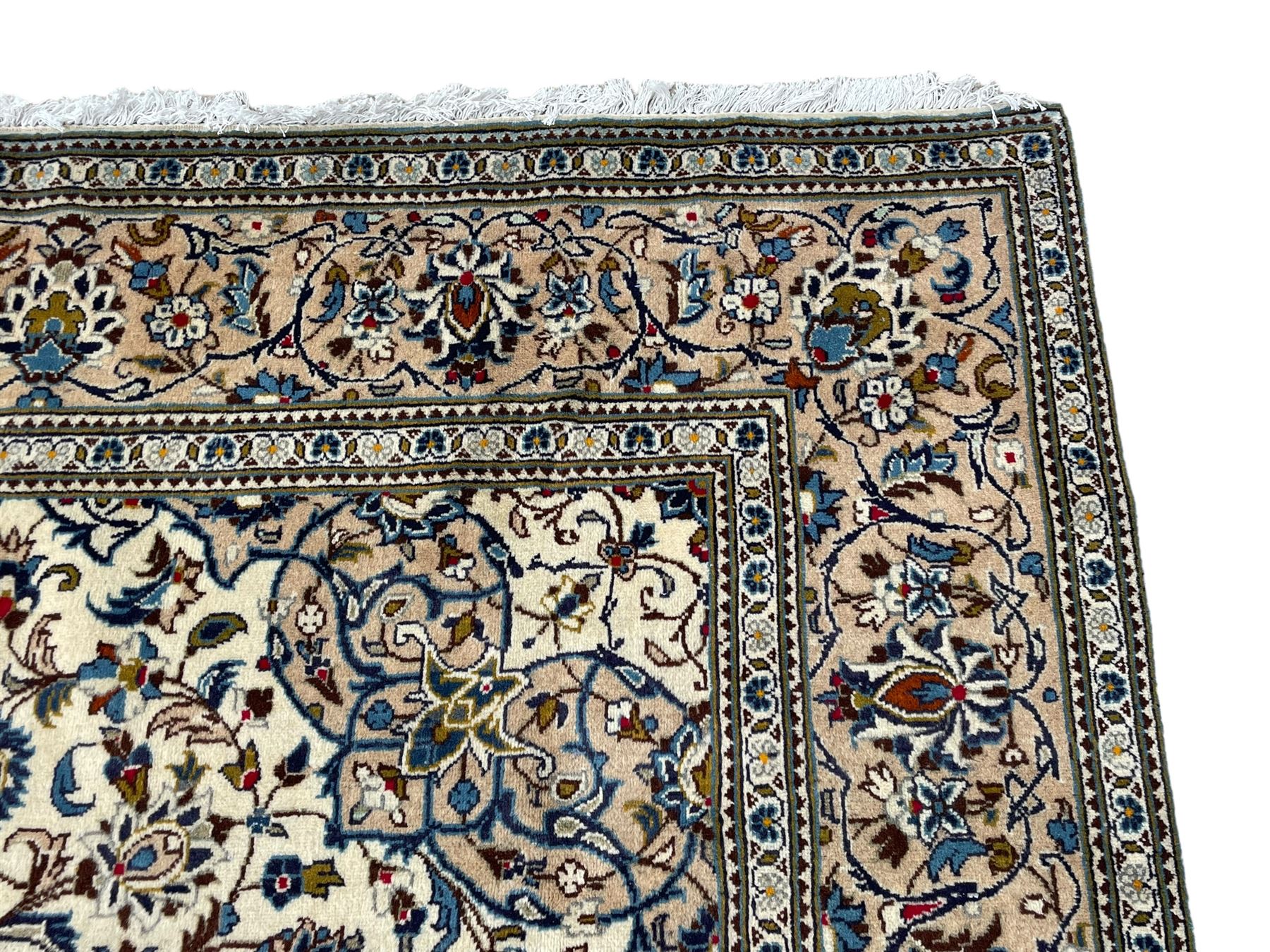 Persian Kashan ivory ground rug, central floral medallion surrounded by interlacing leafy branches and stylised plant motifs, scrolling spandrels, the border decorated with trailing branch and repeating palmettes, within floral pattern guard stripes 