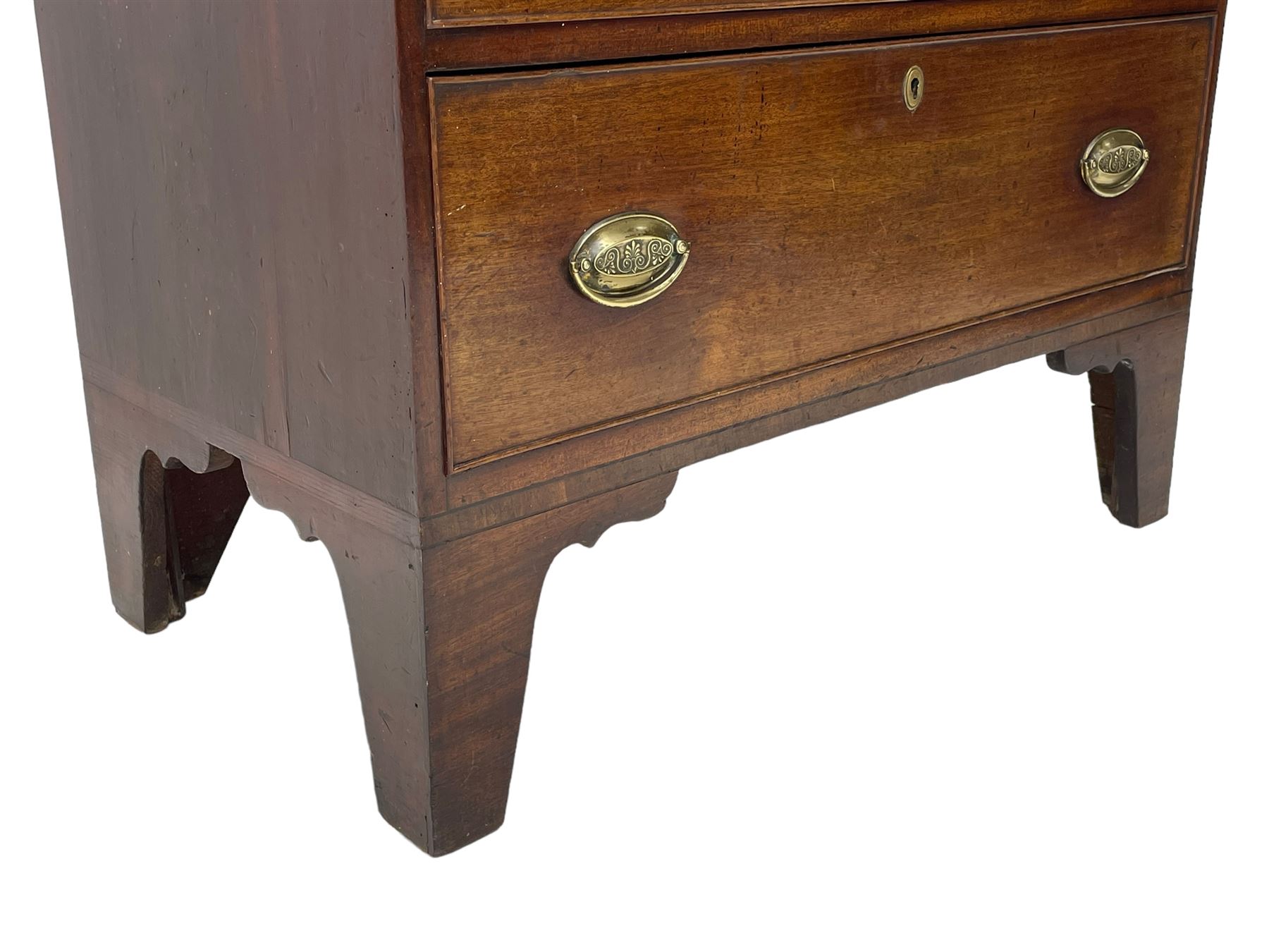 George III mahogany chest, rectangular ebony strung top, fitted with three graduating cock-beaded drawers with oval pressed brass handle plates and demi-lune handles, on tall bracket feet 