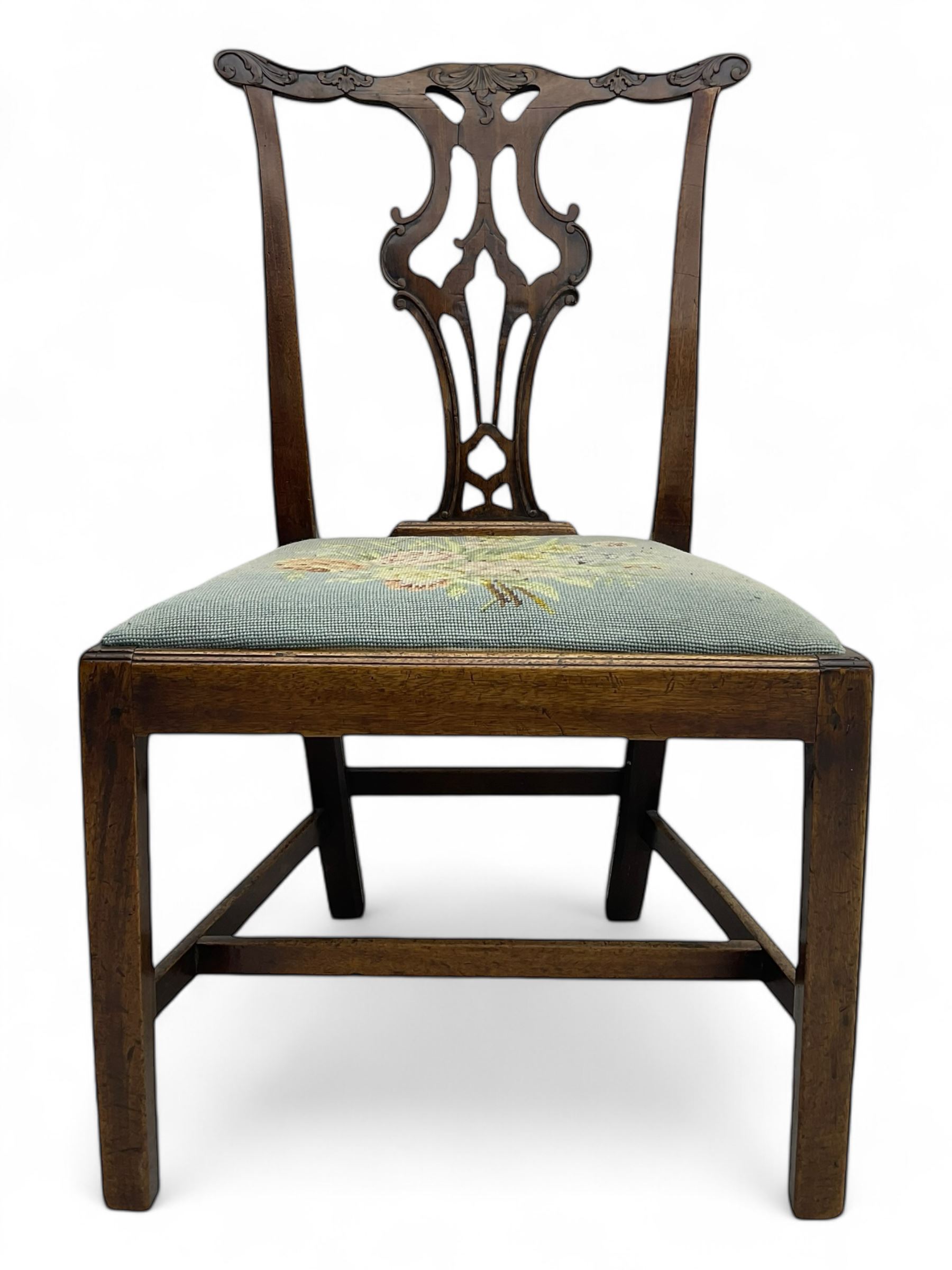 George III Chippendale design dining chair, shaped cresting rail carved with foliate scrolls over pierced and carved splat, floral needle-work upholstered drop-in seat, on square moulded supports united by H-stretchers 