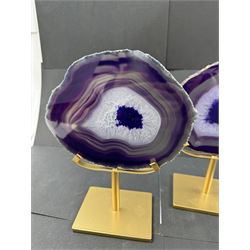 Pair of purple agate slices, polished with rough edges, raised upon gilt metal stands, H22cm