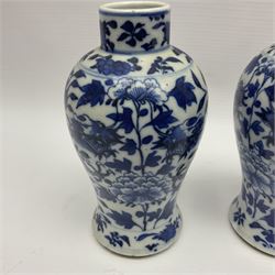 Pair of late 19th/early 20th century Chinese blue and white vases, each of baluster form, painted with dragons amidst flowers, each with Kangxi character marks beneath, H14cm 