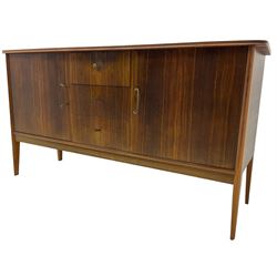 Mid 20th century teak sideboard, rectangular top with rounded corners over three central drawers, flanked by two cupboard doors enclosing shelves, raised on tapered supports