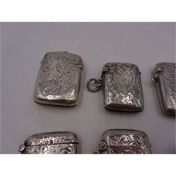 Seven early 20th century silver vesta cases, all of typical form, engraved with foliate and scrolling details, all hallmarked