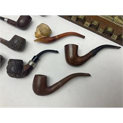 Collection of smoking pipes including Meerschaum pipe, carved as a female head, Briars and clay examples, etc and four pipe racks/stands