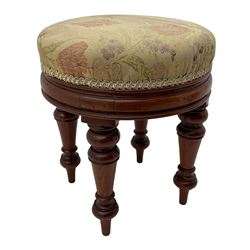 Pair of Victorian walnut circular stools, cushioned seats upholstered in floral pattern fabric, moulded seat rail over turned supports 