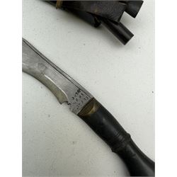 British Service issued Kukri, circa 1980s, with curving blade, hardwood and brass grip in leather covered scabbard with two skinning knives, blade, stamped 12th  December 1980 Dharan Nepal to blade, blade L28cm, overall L39cm