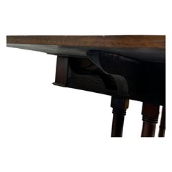 Mahogany drop-leaf sofa table, rectangular top over single frieze drawer with carved rosette handle, twin turned columns united by twin stretchers, on splayed supports terminating in paw feet with castors