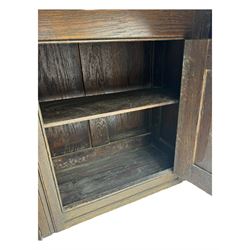 Victorian carved oak kneehole desk, the rectangular top with carved edge, above central drawer with carved front and brass handles, central kneehole with cupboard door, flanked by two banks of three graduating drawers each with similarly carved decoration, on shaped plinth base with castors