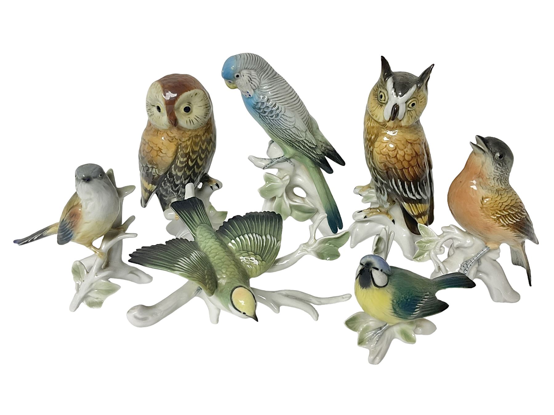 Seven Karl Ens bird figures, including barn owl, eagle owl, blue tit, budgerigar etc, all with mark beneath, tallest H17cm 