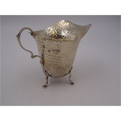 Edwardian silver jug, of helmet form with planished decoration throughout, upon three hoof feet, hallmarked Charles Boyton & Son Ltd, London 1906, H9cm