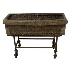 Early 20th century GPO wicker and hide bound postal trolley, on a cast iron base with castors