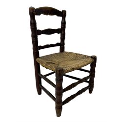 19th century painted elm primitive fire side chair, ladder back over rush seat, on turned supports united by turned stretchers 