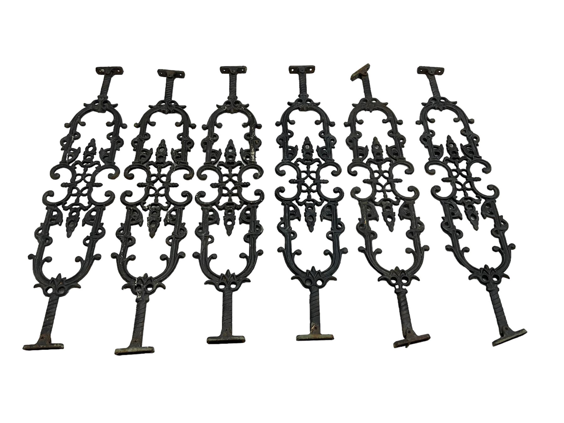 Set of twelve 20th century cast iron staircase baluster rails or balustrade, decorated with foliate scrolls