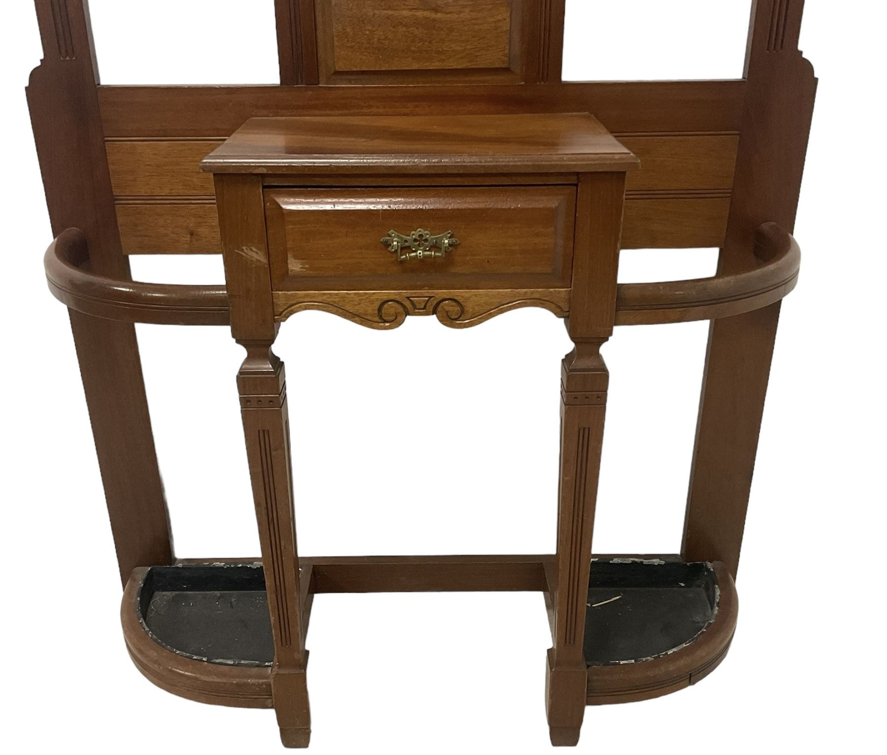 Late Victorian hallstand, raised pediment over balustrade frieze, bevelled mirror back with coat hooks over glove drawer, fitted with two drip-trays to base