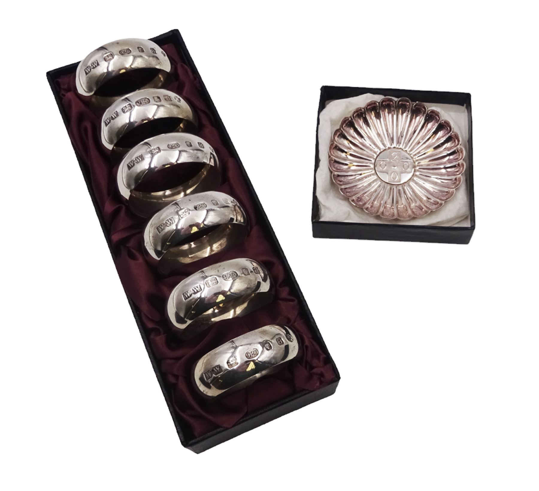 Set of six modern silver napkin rings, hallmarked London 2000, makers mark WW, together with a modern silver pin dish, hallmarked Hugh Crawshaw, Sheffield 2000, both boxed