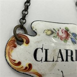 Two late 18th/early 19th century enamel wine labels, each of shaped form, titled 'CLARET', and 'SHERRY' and decorated with floral sprigs and scroll detail upon a white ground, each with suspension chain, each approximately H3.5cm W5cm