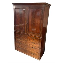 Victorian mahogany linen-press, moulded cornice over two figured panelled doors, the interior fitted with five slides and hanging rail, four long drawers below 