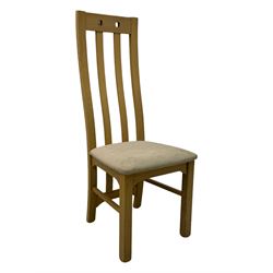 Contemporary set of four oak dining chairs, tall slatted curved backs with square cutouts to the top, upholstered seats in light fabric, on square front supports