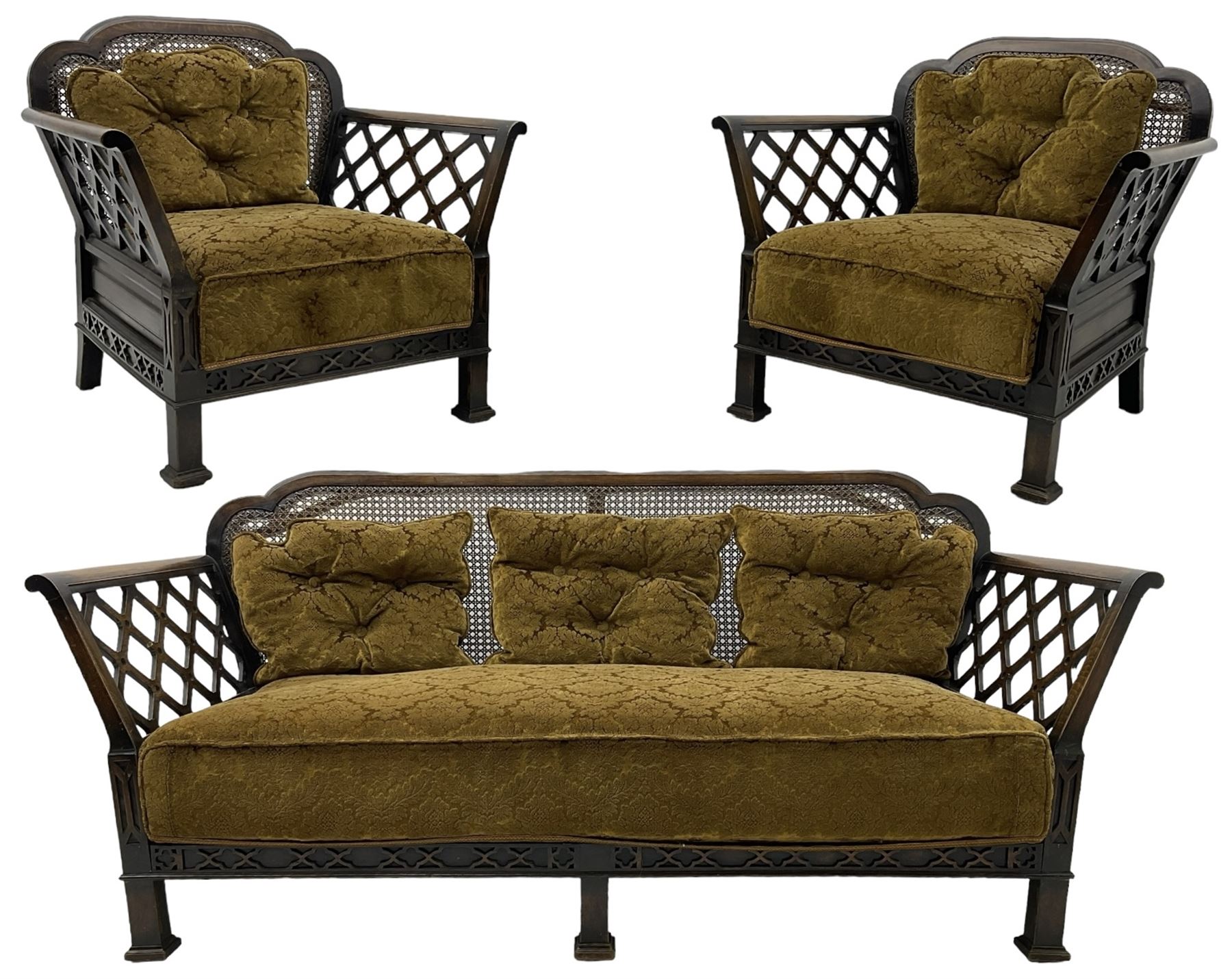 Early 20th century three-piece bergère suite - three seat sofa (W177cm, H82cm, D75cm); pair of matching armchairs (W84cm); single caned back with 'cock-pen' panelled arms, upholstered in foliate pattern fabric, blind fretwork lower frieze over square feet 