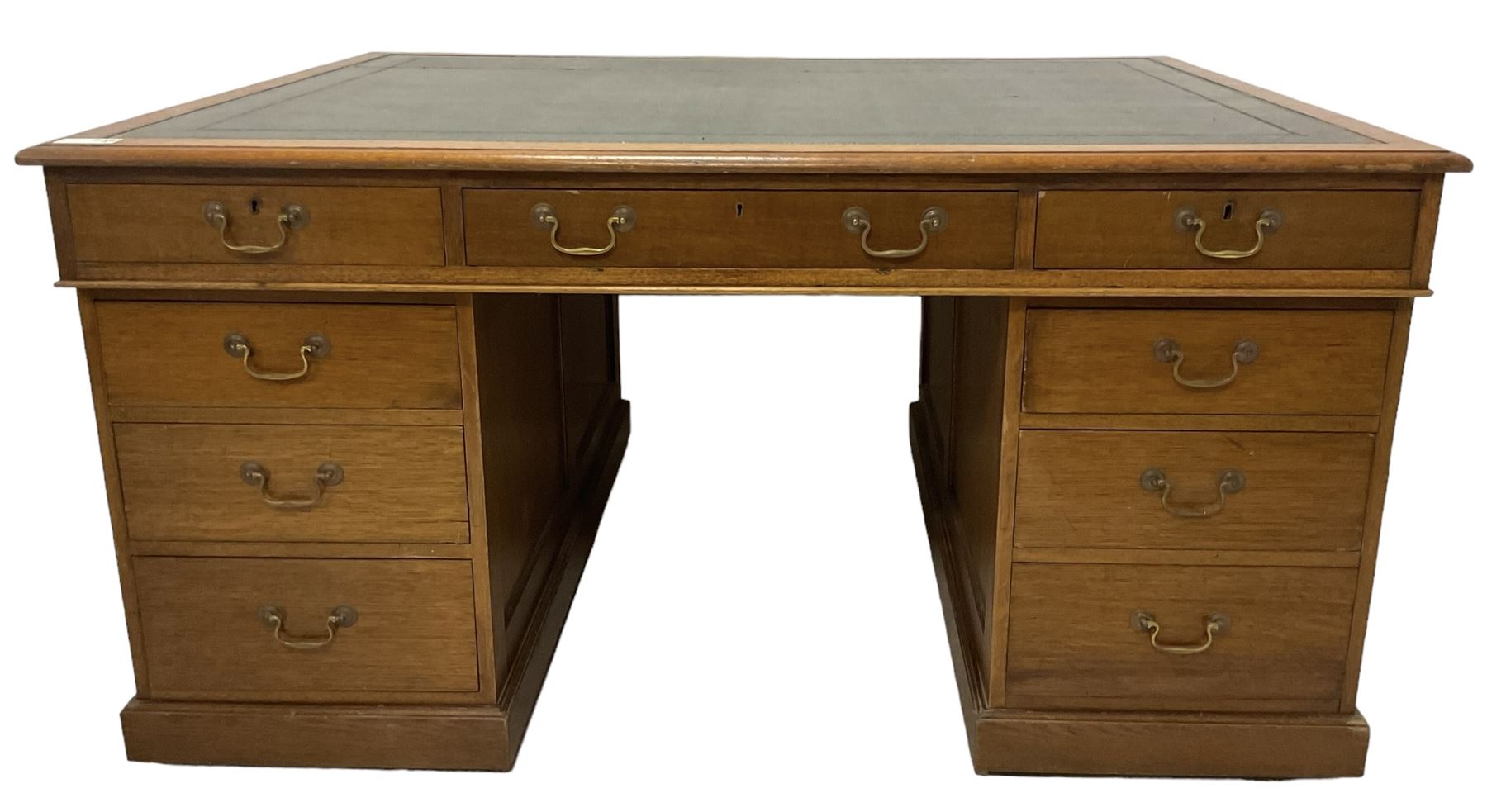 Late 19th century twin pedestal oak partner's desk, rectangular top with inset green leather writing surface, fitted with nine graduating drawers to each side, the rear drawers enclosed by panelled cupboards