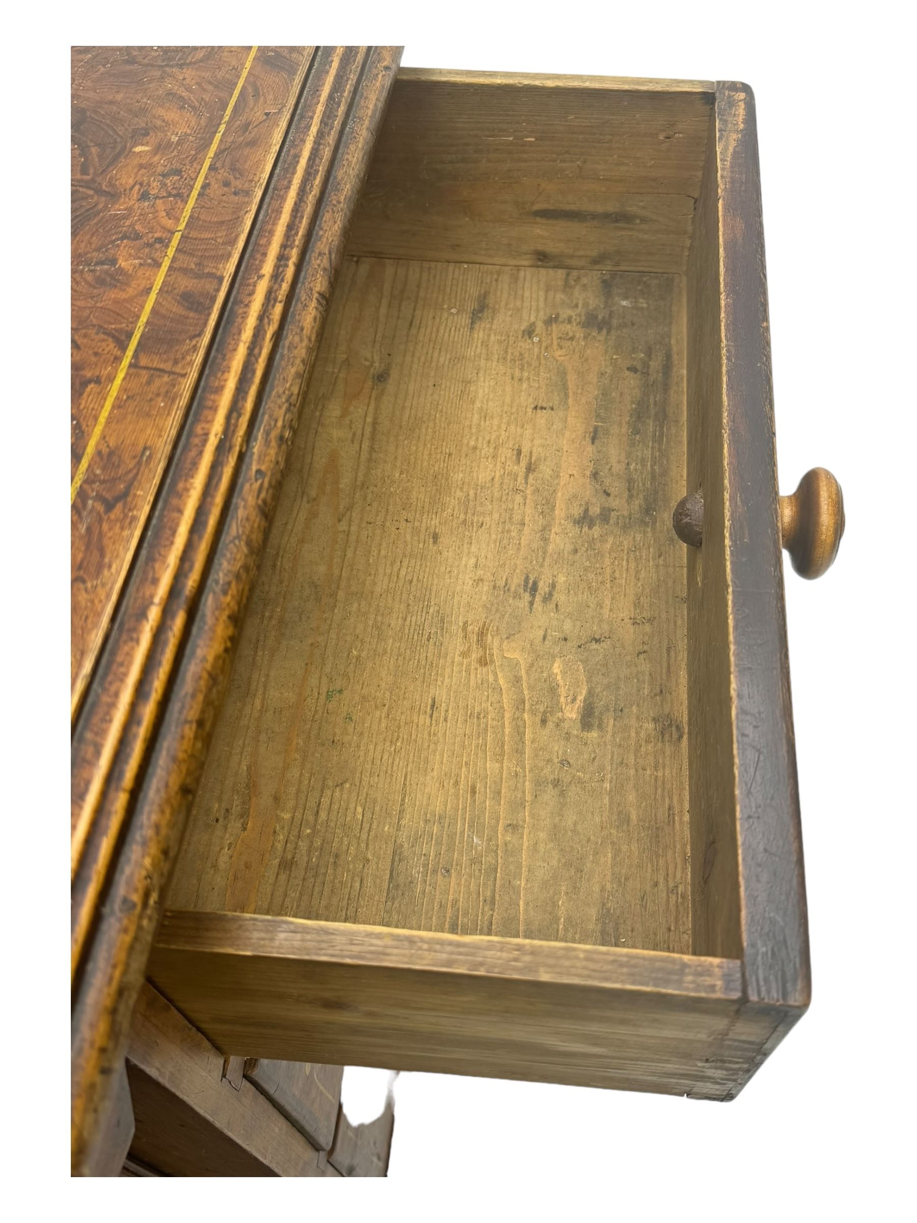 Victorian walnut scumbled pine sideboard, stepped rectangular top over central cupboard with marquetry inlay, flanked by two banks of three drawers fitted with round wooden knobs, raised on turned bun supports