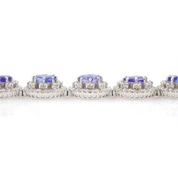 18ct white gold tanzanite and diamond bracelet, twelve oval link clusters set with oval cut tanzanite's and round brilliant cut diamonds, stamped 750, total tanzanite weight approx 11.00 carat, total diamond weight approx 3.65 carat