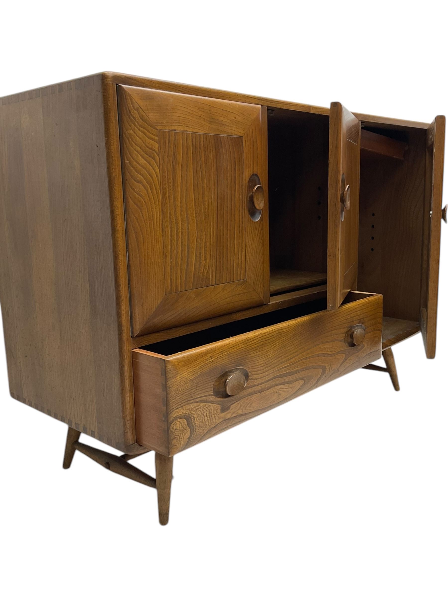 Lucian Ercolani for Ercol - 1960s elm sideboard, fitted with double cupboard, single cupboard and drawer, on tapering supports 