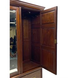 Late Victorian walnut triple wardrobe, projecting moulded cornice over central bevelled mirror door and flanking panelled doors, the top panels carved with fluted fans and stylised leaf motifs, the interior fitted with three linen slides, two drawers and hanging space, two long drawers to base, reed moulded uprights and vertical fluted horizontal rails 