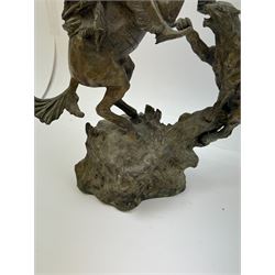 After Charles Marion Russell; Bronzed sculpture depicting man on horseback fighting a mountain lion, H42cm