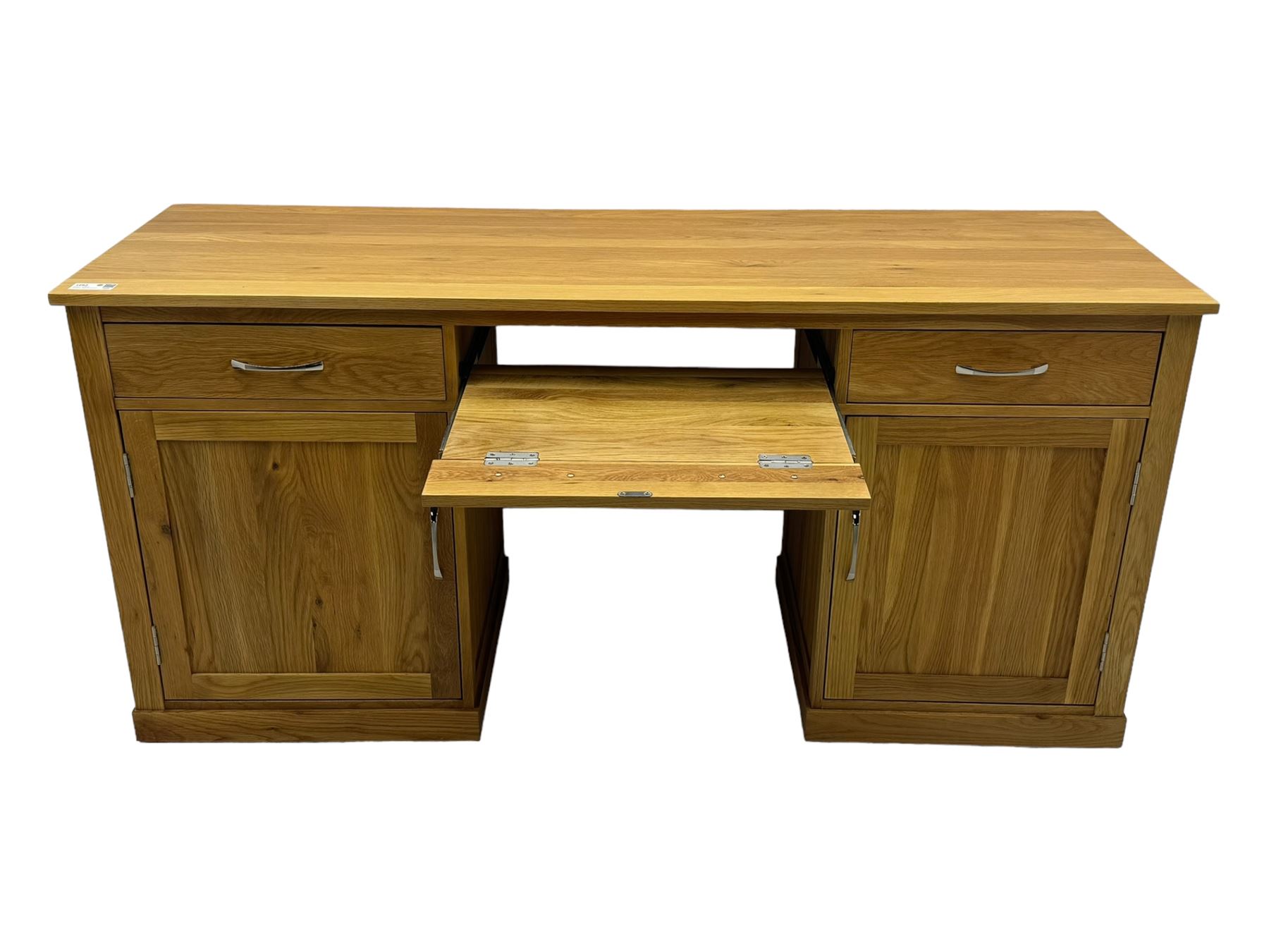 Contemporary light oak twin pedestal desk, fitted with three drawers over two cupboards with chrome handles, the central drawer with hinged front panel revealing pull-out keyboard tray, on plinth base