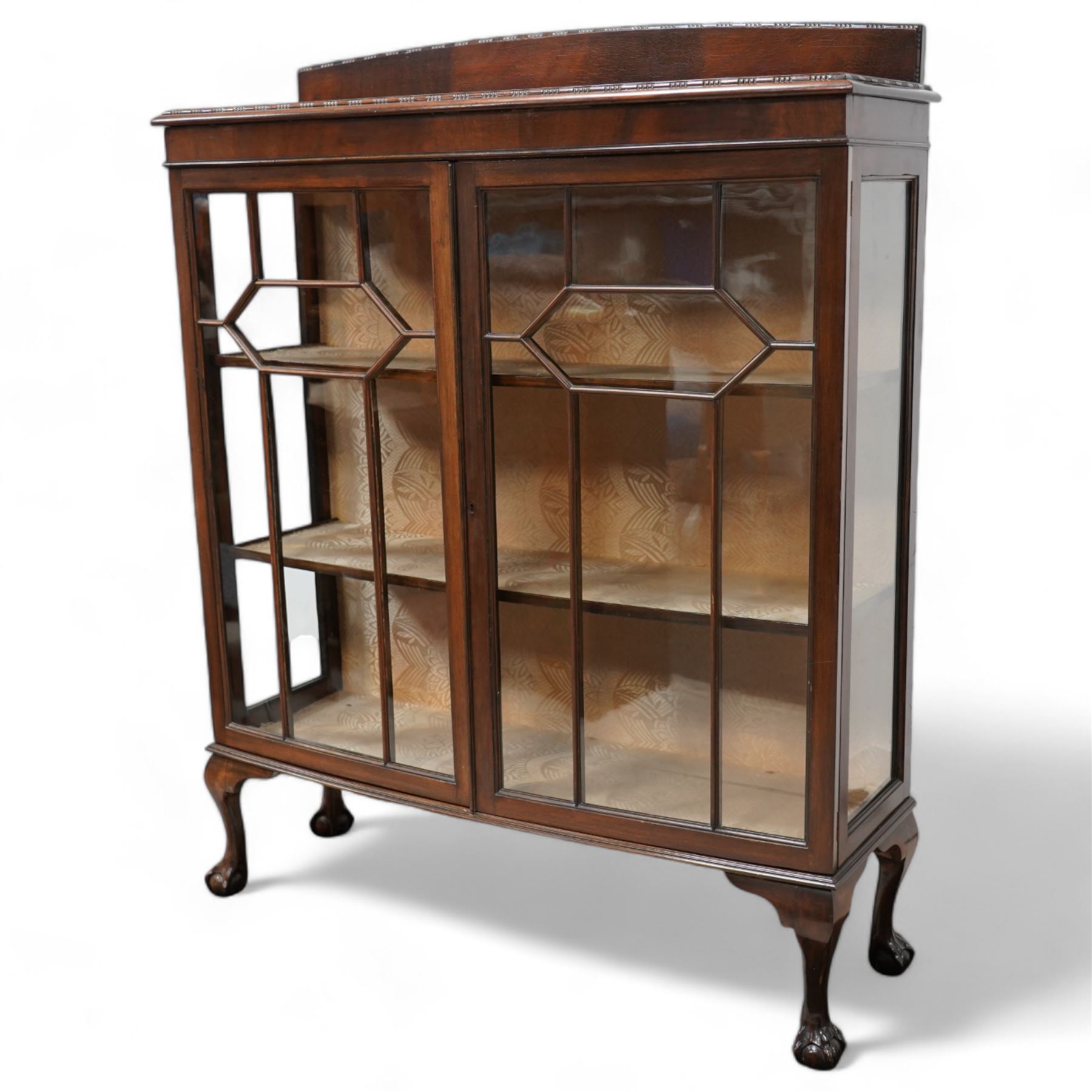 Early 20th century mahogany bow-front display cabinet, fitted with two astragal glazed doors enclosing two shelves, on cabriole supports with ball and claw feet