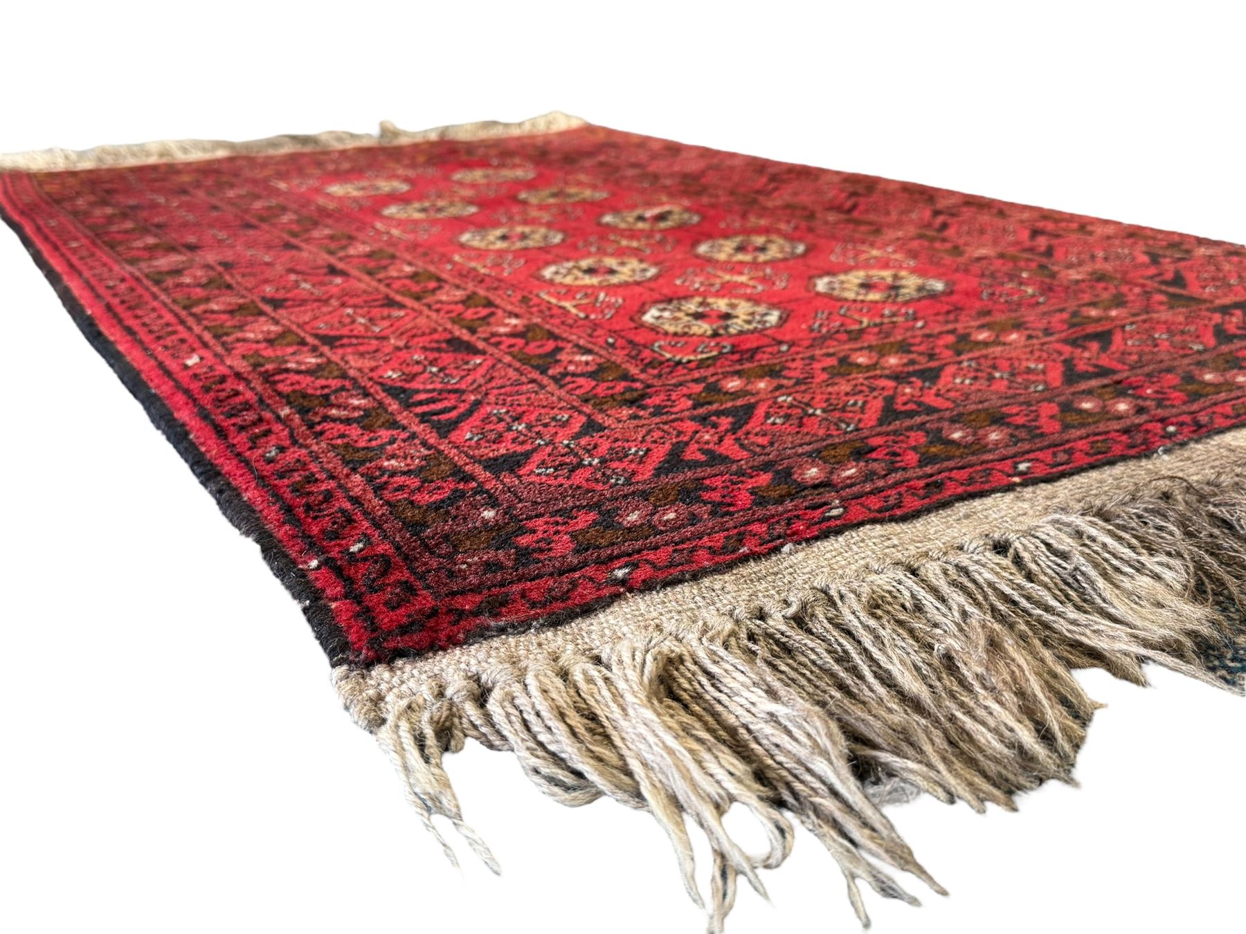 Afghan red ground Bokhara rug, decorated with four central Gul motifs, enclosed by wide geometric guard bands (191cm x 104cm); together with another similar (120cm x 79cm)