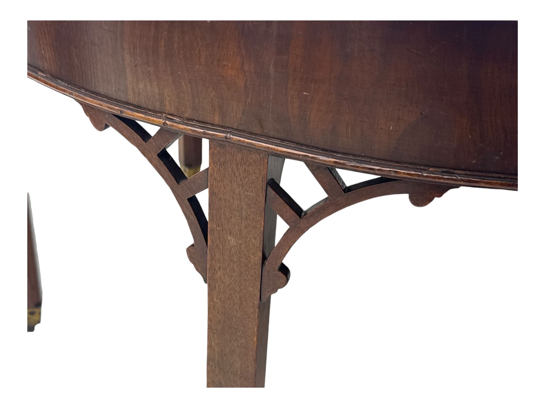 Early 19th century mahogany demi-lune extending dining table, two D-ends with central leaf insert, raised on eight square supports with arched spandrels terminating in brass castors