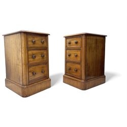 Pair of Victorian figured mahogany pedestal chests, rectangular form with rounded front corners, moulded top over three drawers with applied mouldings and turned handles, on moulded plinth base