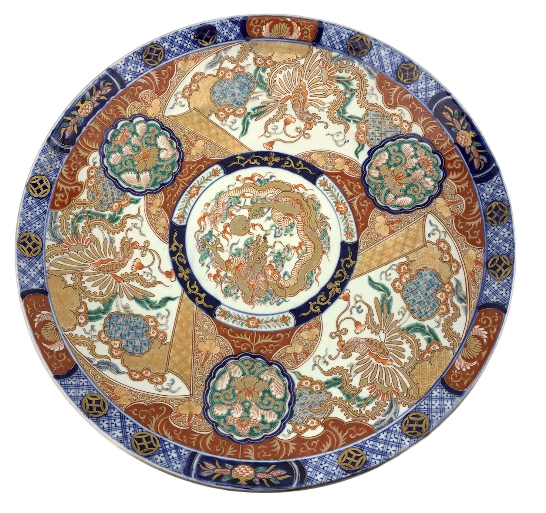 Large Japanese Meiji Period charger, decorated in the Imari palette with Dragons chasing the flaming pearl, roundels and foliate decoration, D46cm