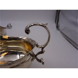 Near pair of George II silver sauce boats, each of oval form with shaped rim and capped flying scroll handle, upon three scroll mounted feet, hallmarked David Hennell, London 1758, H12cm