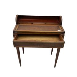 Early 20th century French plum pudding mahogany petite writing desk, barrel tambour roll top, fitted with a single cock-beaded drawer activating the tambour roll, the fold-over writing slope with inset writing surface supported by long drawer, fitted with three small drawers and pen rail, raised on fluted tapering supports