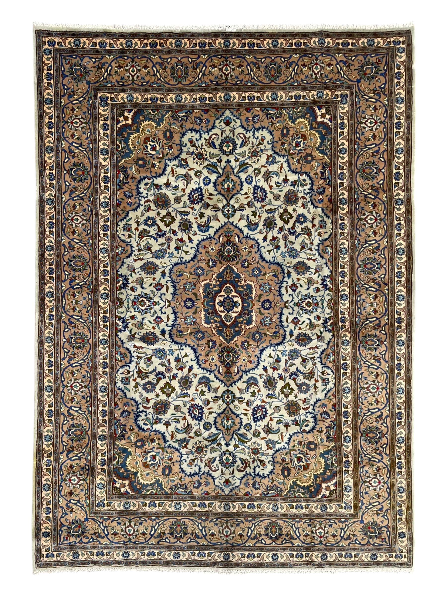 Persian Kashmar pale green ground rug, shaped central medallion decorated with stylised flower heads, the surrounding field with scrolling leafy branches and palmettes, the spandrels and border decorated with further palettes, within floral pattern guard stripes