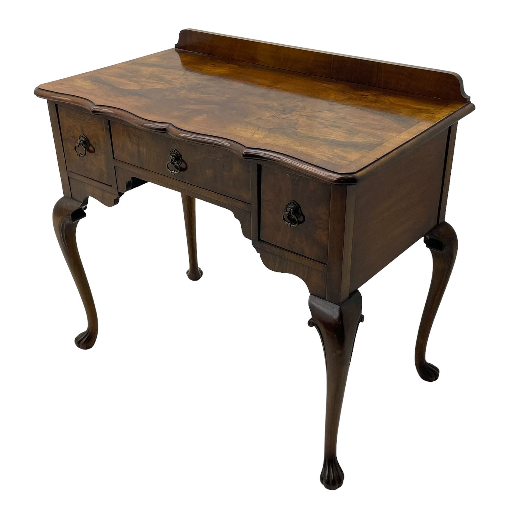 Mid-to-late 20th century figured walnut side table, raised back over figured top with cross banding and shaped front, fitted with three drawers, on cabriole supports with carved terminals 