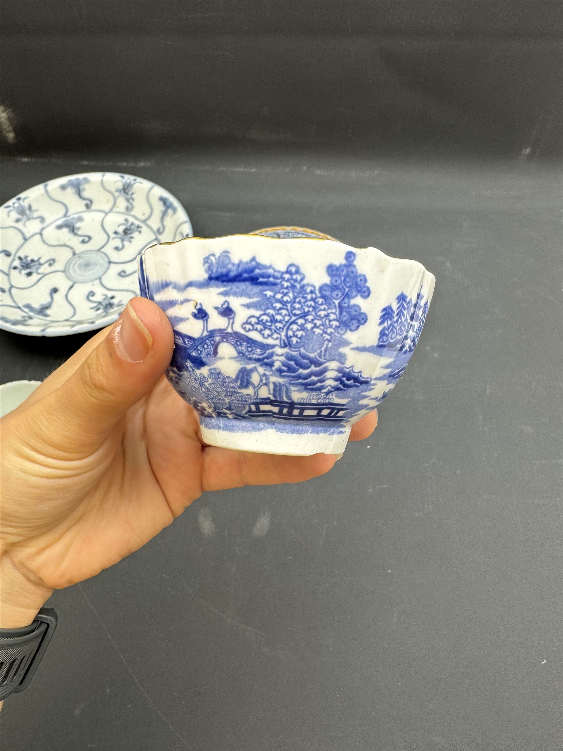 Early 19th century Chinese Tek Sing bowl, decorated with stylised blossoms, with 'Nagel Auctions' label to base, H6.5cm D15.5cm, together with a  Tek Sing similar saucer, D18cm, a Chinese tea bowl decorated in blue and red blossoming flowers, a Chinese blue and white saucer, and an English blue and white Willow pattern tea bowl, (5)