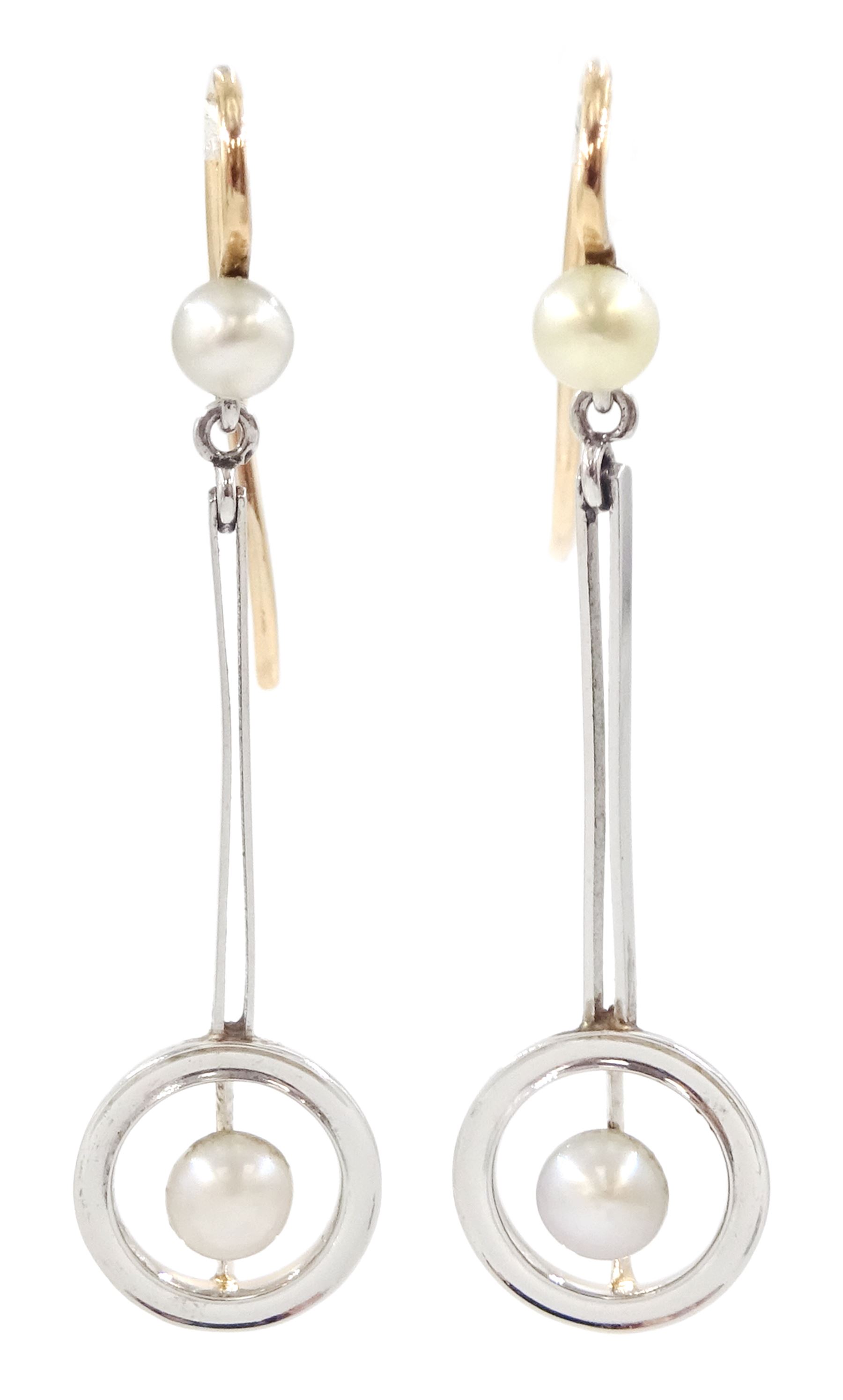 Pair of early 20th century 15ct gold and platinum pearl pendant earrings, pearls within hoop frames and suspended from knife edge bars to pearl surmounts 