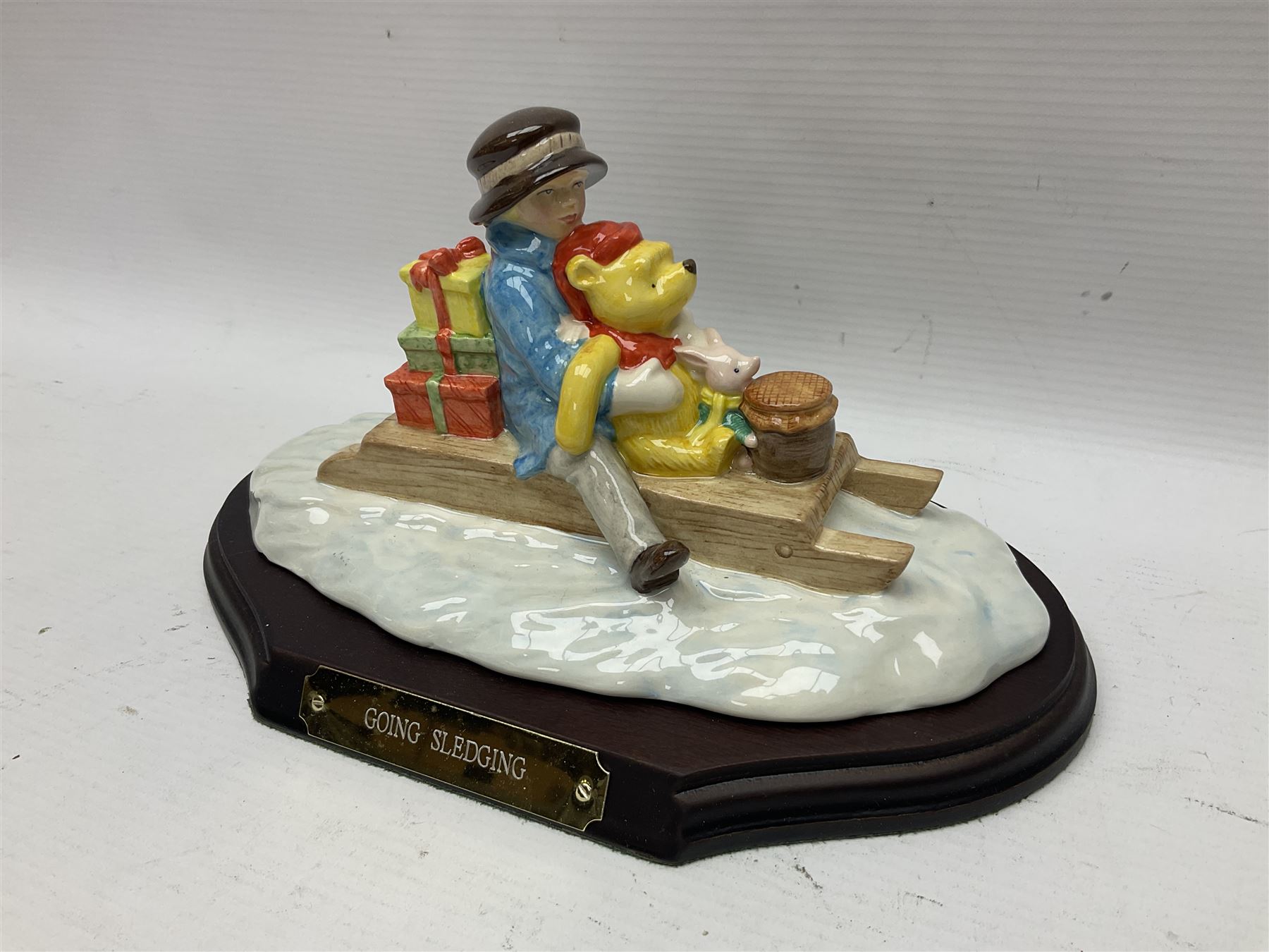 Nine Royal Doulton Winnie the Pooh Collection figures, including Oh Dear Bath Time's Here, Going Sledging, Tigger's Splash Time and Christopher Robin, together with a Royal Doulton Disney Showcase Jiminy Cricket figure, all boxed