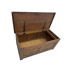 18th century oak blanket box, rectangular form with a hinged lid, the front decorated with raised geometric panelled mouldings, fitted with a central lock plate, raised on bracket feet