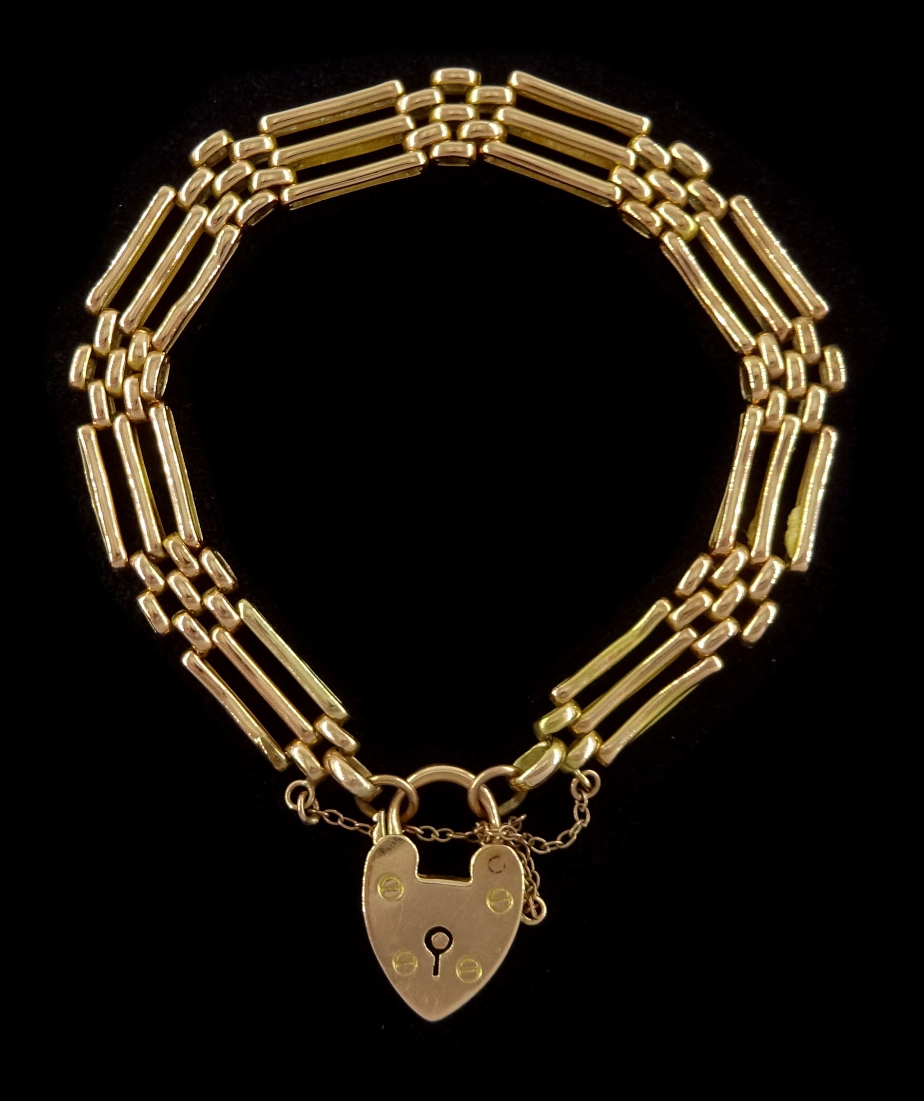 Early 20th century 15ct rose gold three bar gate bracelet, with heart locket clasp, stamped 15